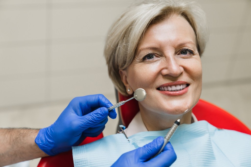 elderly woman smiling in dental chair
