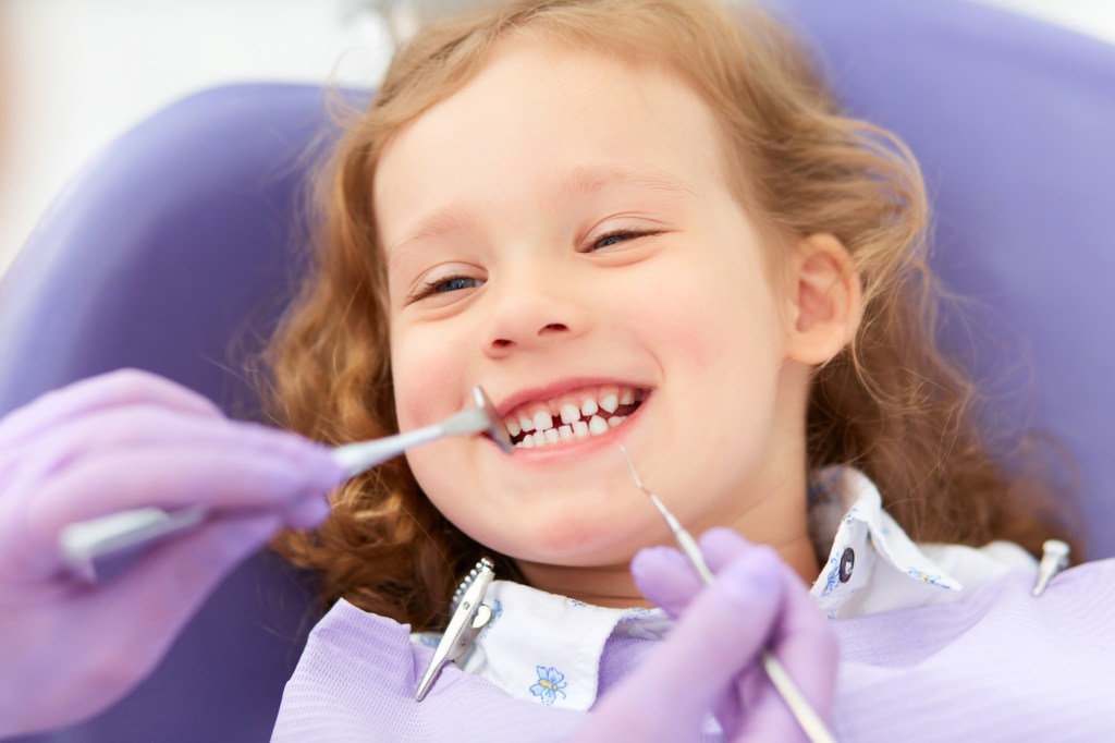 female child receiving a dental exam