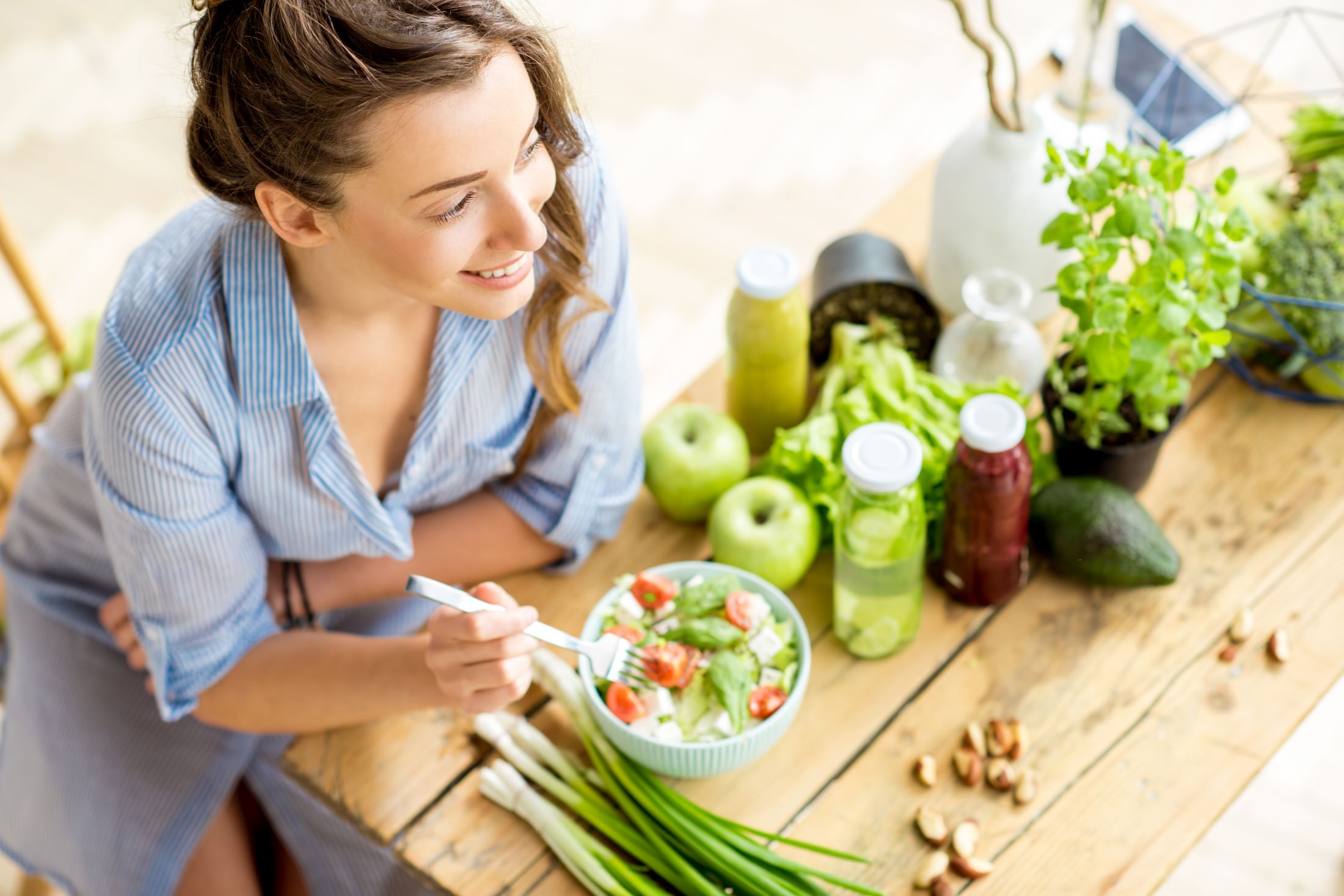 Older woman with healthy teeth eating and enjoying a green apple