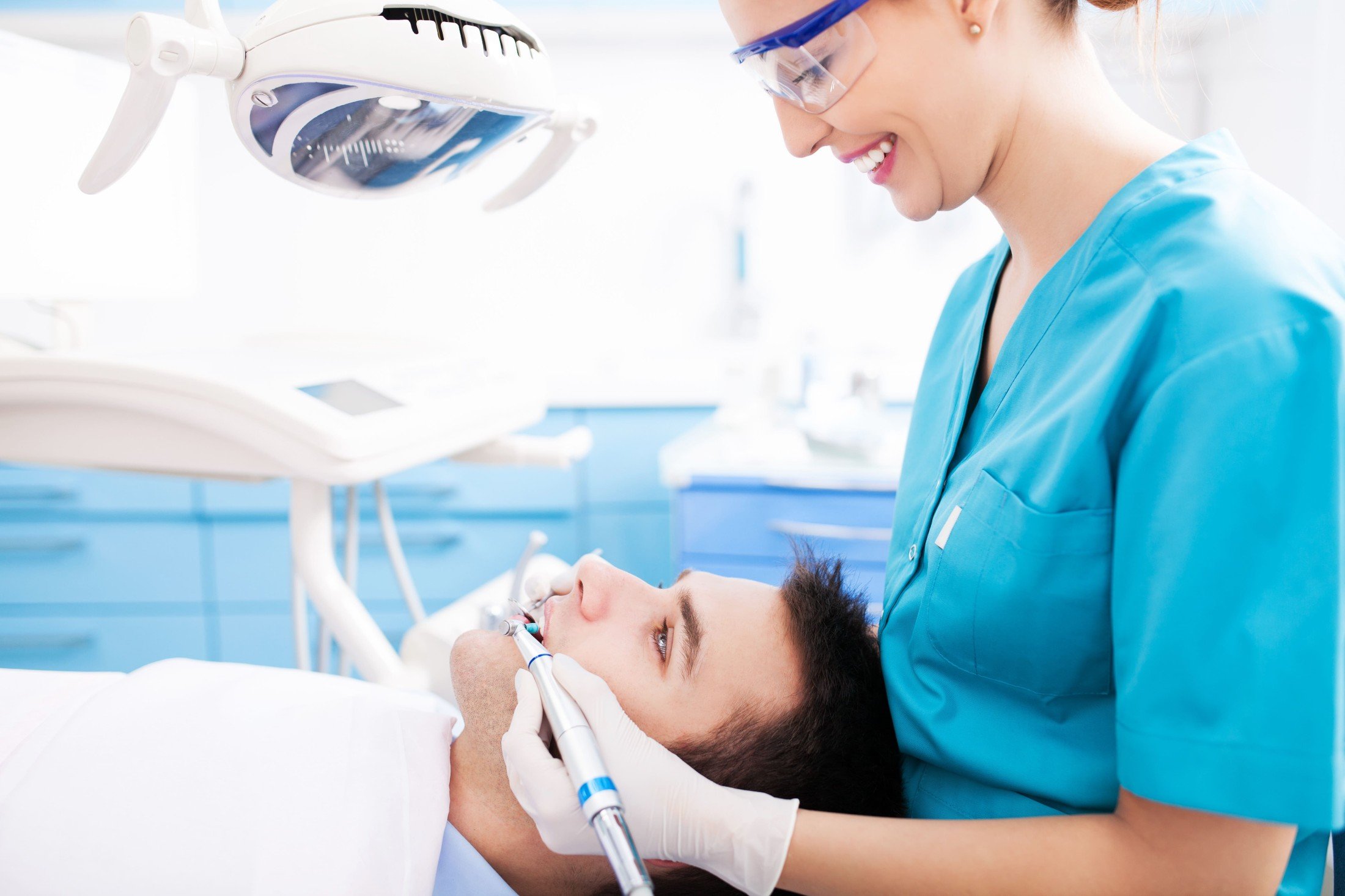 Dentist Cleaning Patient Teeth