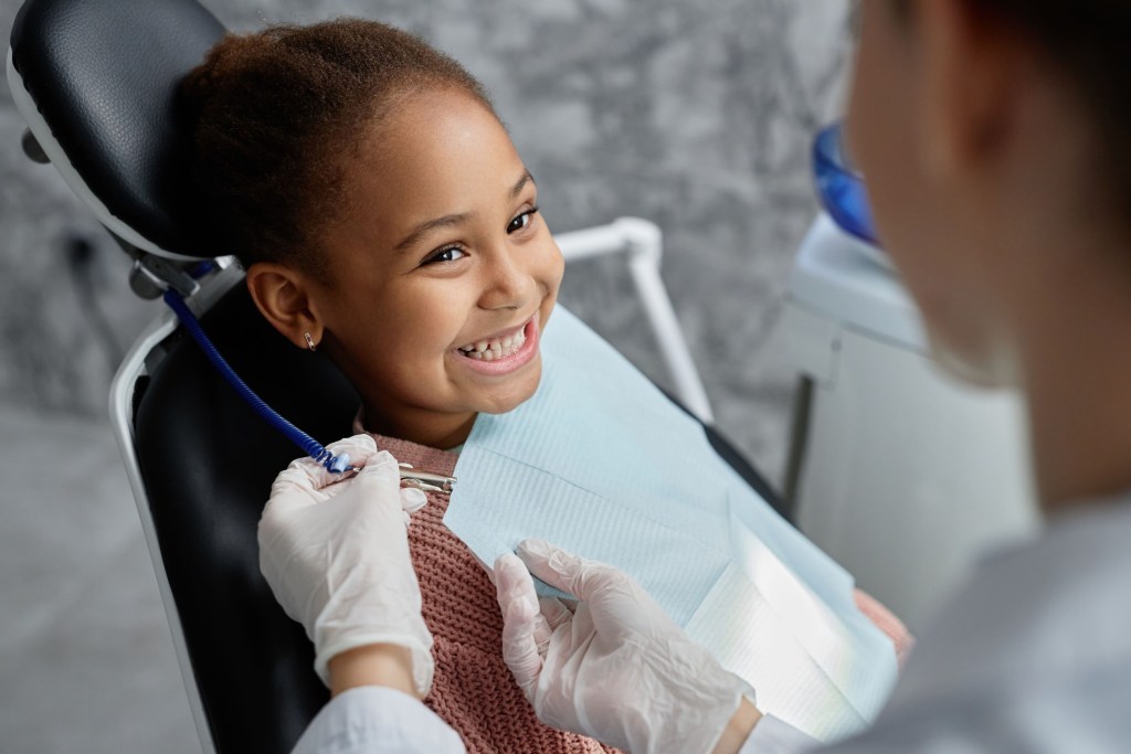 portrait smiling girl in dental chair