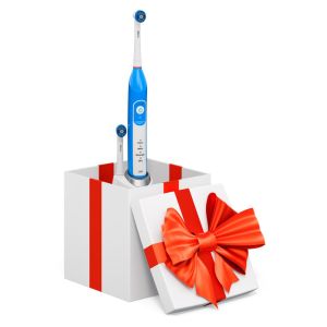 electric toothbrush coming out of a white and red gift box